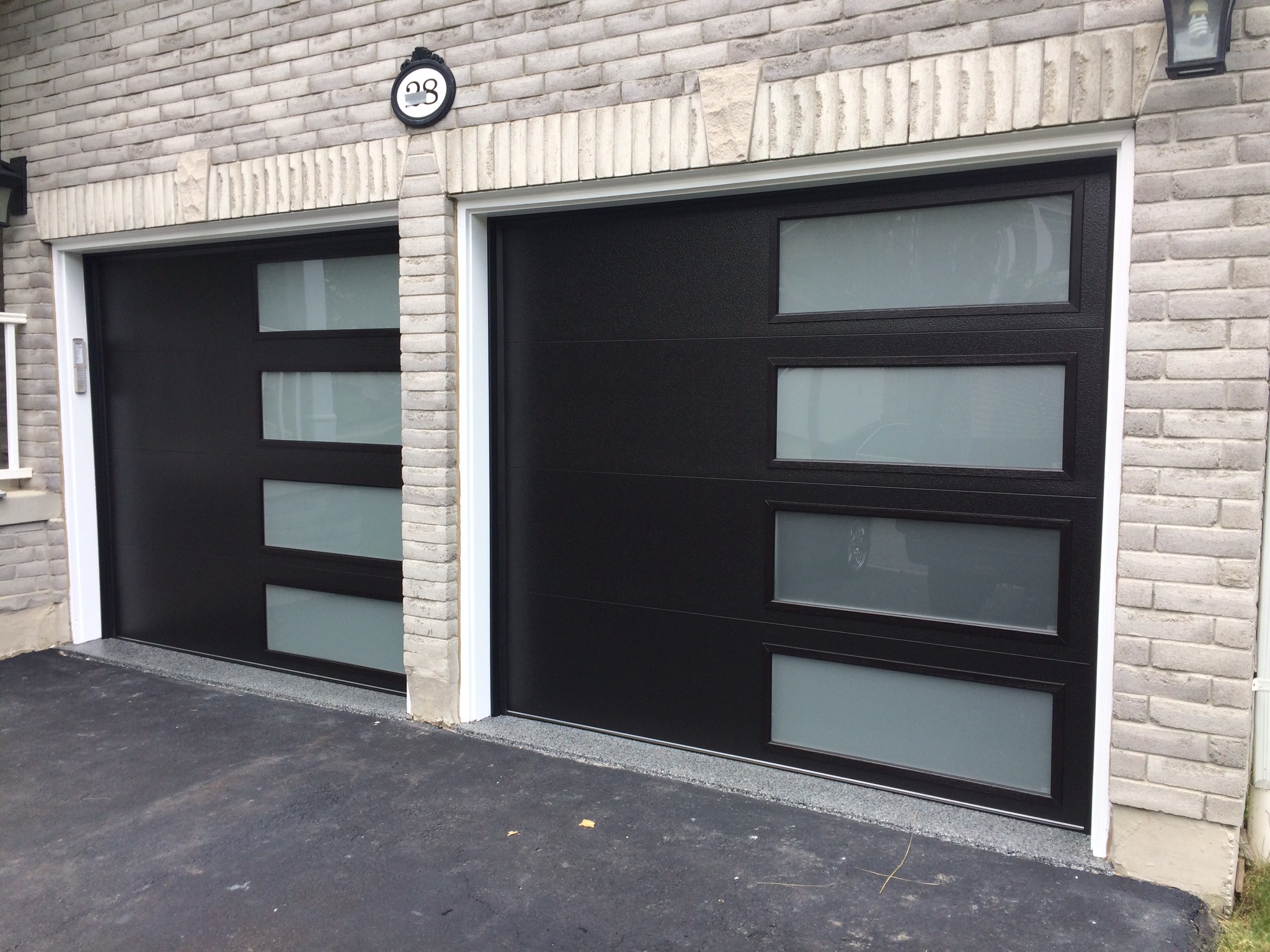 Modern black garage door with frosted windows
